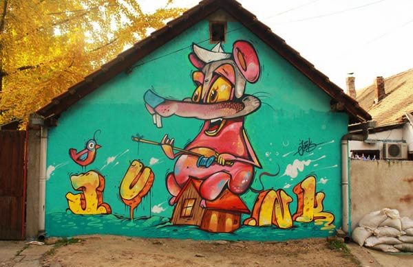 Urban art by Junk in Serbia called When the cat's away the mice will play | summer street art
